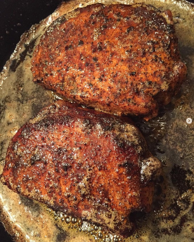 Two seared pieces of meat on a hot surface and seasoned with Chef Tim's Cajun Cool Blackened Seasoning.  A delightfully mild (4 out of 10) Cajun seasoning that tantalizes the senses but doesn't burn you. "Spicy but not hot."   

Made with both Hungarian sweet and Spanish smoked paprika. Naturally Gluten Free, Cholesterol Free & No MSG. 