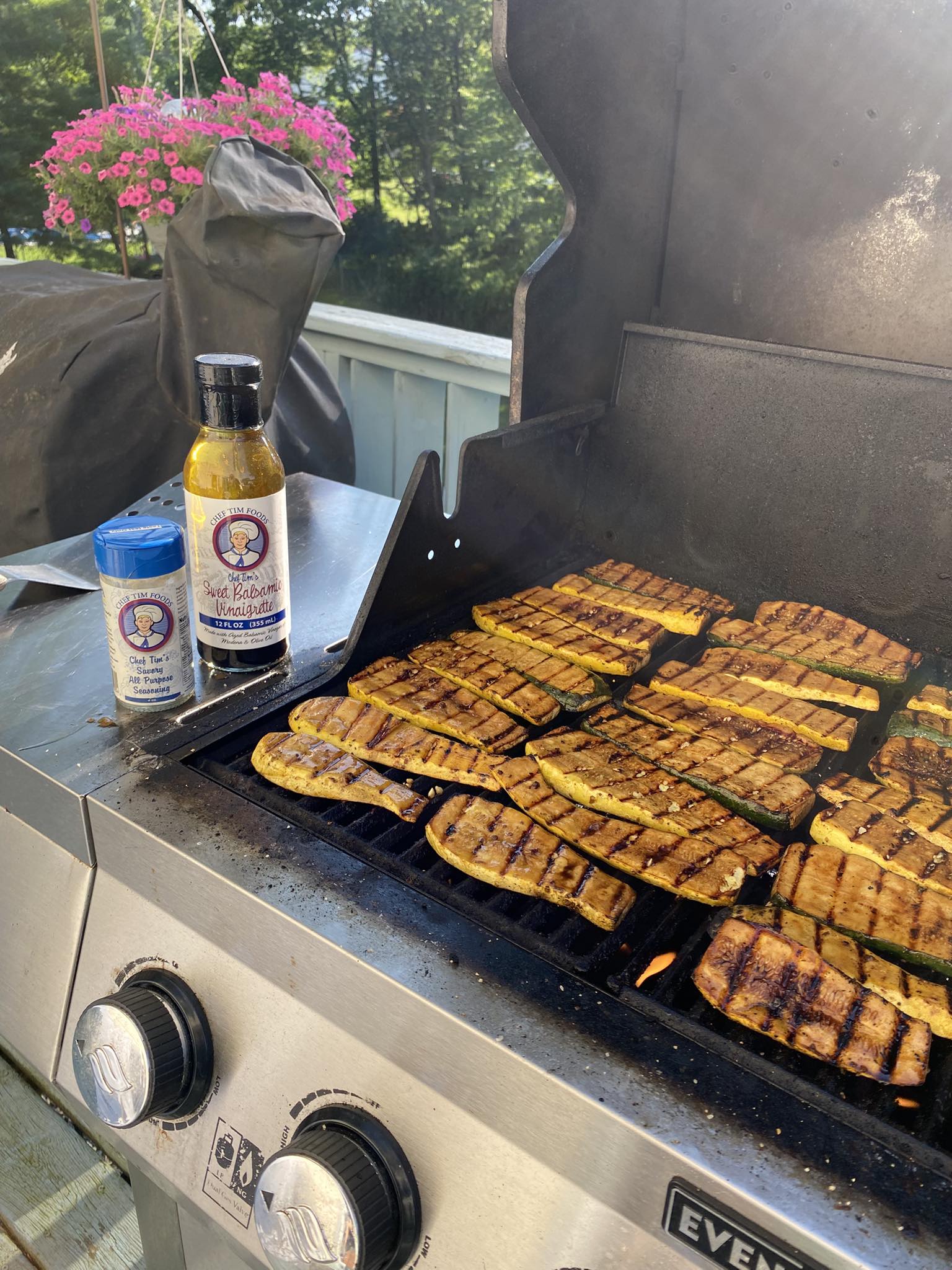 Zucchini slices being grilled after marinated in Chef Tim's Sweet Balsamic Vinaigrette salad dressing and marinade.  Made with 7 natural Ingredients and is Gluten Free & Cholesterol Free & No MSG
 Makes a Great as a Gift for people who love to cook and desire to eat healthy, and/or gluten free.  Made in USA.
"Shake, Shake, Shake. Don't Refrigerate"©
On a barbecue with a bottle of sauce and container of Chef Tim's Savory All purpose  seasoning nearby.